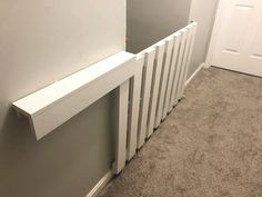 a white radiator in the corner of a room with carpet on the floor