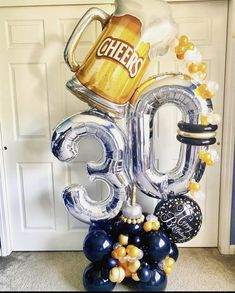 a balloon shaped like the number thirty five with beer mugs and balloons attached to it