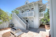 a white house with stairs leading up to it