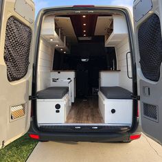 the interior of a van with its doors open and two seats in the back area