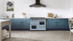 a kitchen with blue cabinets and an oven