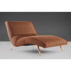 an upholstered chaise lounge chair with wooden legs and footrests in brown fabric