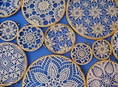 blue and gold lace doily on a blue tablecloth with white flowers in the center