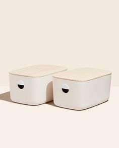 two white storage containers sitting on top of each other