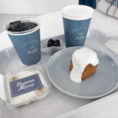 a tray with some cupcakes and drinks on it