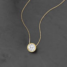 Ross-Simons - 1.20ct Bezel-Set Diamond Solitaire Necklace in 14kt Yellow Gold. 16". Utterly classic, this diamond necklace is a wardrobe essential. A marvelous 1.20 carat bezel-set round brilliant-cut diamond glows from polished 14kt yellow gold on a sleek box chain. Will add timeless diamond shimmer to your elegant everyday ensembles. Springring clasp, diamond necklace. Diamond birthstones are the perfect gift for April birthdays. Luxury Timeless Solitaire Diamond-cut Necklace, Luxury Dainty Diamond Necklace With Brilliant Cut, Luxury Classic Solitaire Necklace With Brilliant Cut, Diamond Solitaire Necklace Size, Luxury Solitaire Diamond Necklace Vs Clarity, Delicate Diamond Necklace Pendant, Diamond Solitaire Necklace Setting, Classic Diamond Necklace With Bezel Setting, Classic Yellow Gold Solitaire Necklace With Single Cut Diamonds