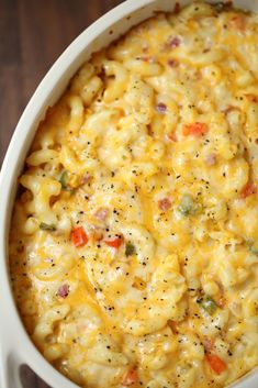 macaroni and cheese in a white dish on a wooden table