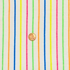 a button that is on the side of a shirt with multicolored stripes and a penny