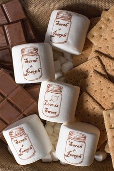 some marshmallows and crackers are sitting on top of each other in front of a bag