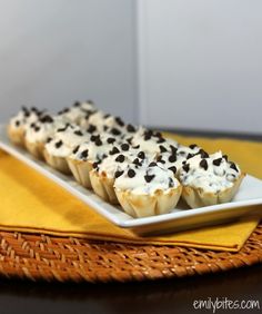 chocolate chip cupcakes with white frosting and sprinkles on a plate