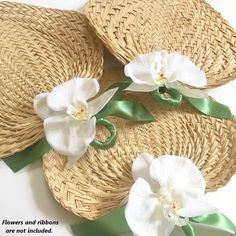 three hats with flowers on them sitting next to eachother's green ribbon