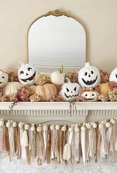 a mantle filled with pumpkins and other decorations