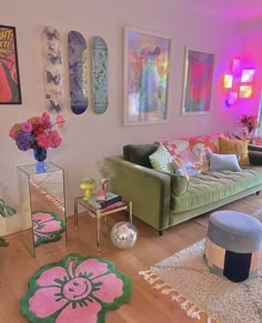 a living room filled with lots of furniture and colorful art on the wall above it