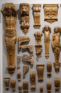 an assortment of carved wooden objects on display