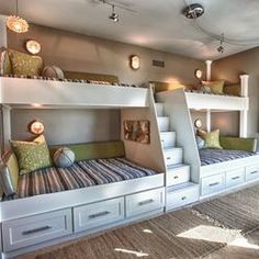 a bunk bed with two sets of drawers underneath it in a room filled with furniture