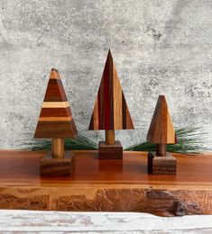 three small wooden trees on top of a table