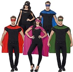 group of people in costumes standing next to each other wearing blindfolds and masks