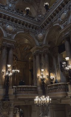 the chandeliers are hanging from the ceiling in this ornately decorated room with high ceilings