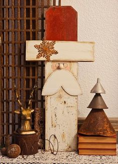 a wooden santa clause sitting on top of a table next to other christmas decorations and candles