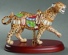 a figurine of a cheetah on a stand