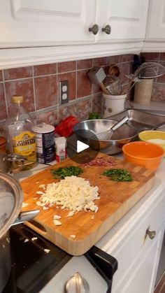 a wooden cutting board sitting on top of a kitchen counter