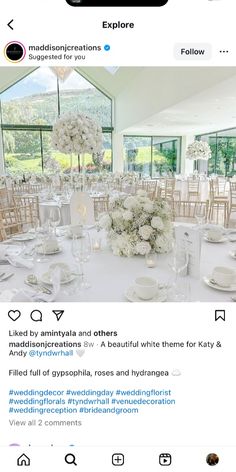 the table is set with white flowers and place settings for guests to sit down at