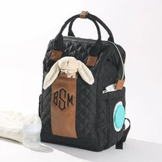 a diaper bag with a stuffed animal in it