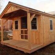 a small wooden cabin sitting on top of a field