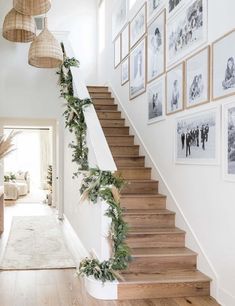 the stairs are decorated with greenery and pictures on the wall