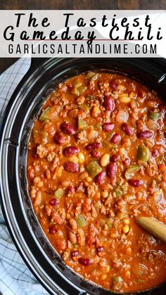 a crock pot filled with chili and beans