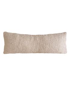 a white and beige pillow on a white background with a black stripe down the middle