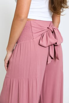 Step into summer with our Tie Waist Tiered Wide Leg Pant in Sunkiss Mauve. Designed for both style and comfort, these pants are the perfect addition to your warm-weather wardrobe. Key Features: Fabric Contents: Made from 100% Rayon, these pants offer a light and breathable fabric that keeps you cool during those hot summer days. Stylish Tie Waist: The tie waist feature not only enhances your silhouette but also allows for a customizable fit, ensuring you look chic while feeling comfortable. Wide