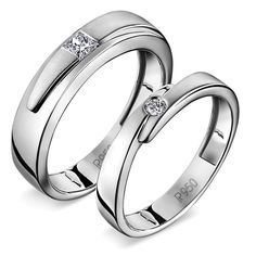 two white gold wedding rings with princess cut diamonds on each one and the other side