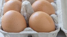 an egg carton filled with brown eggs