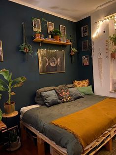 a bed sitting in the middle of a room with lots of plants on top of it