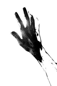 a black and white photo of a person's hand reaching up to the sky