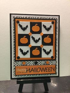 a halloween card with pumpkins and black and white checkerboard on the front