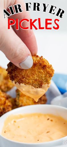 a person dipping some kind of food into a white bowl with sauce in it and the words air fryer pickles above them