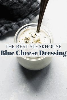 the best steakhouse blue cheese dressing in a small glass jar with a wooden spoon