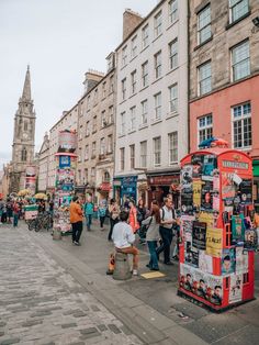 the people are walking down the street in the city