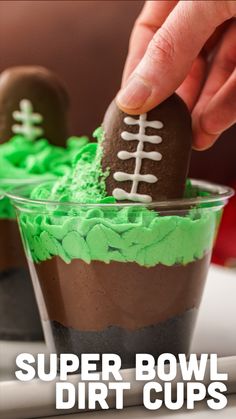 someone is decorating a football cupcake with green frosting