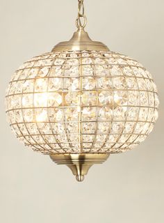 a chandelier hanging from the ceiling with crystal balls on it's sides