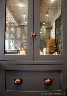 a gray cabinet with two glass doors on it