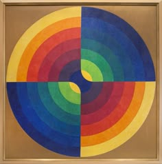 an abstract painting with multicolored circles in the center and one circle at the bottom