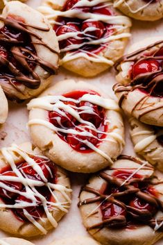 several cookies with white chocolate drizzled on them