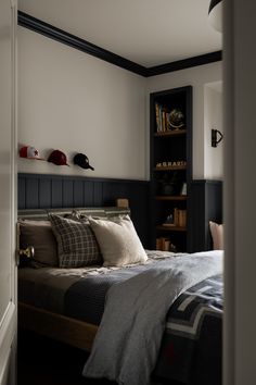 a bed sitting in a bedroom next to a book shelf