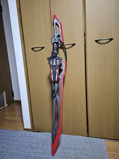 a pair of skis sitting on top of a carpeted floor next to wooden cabinets