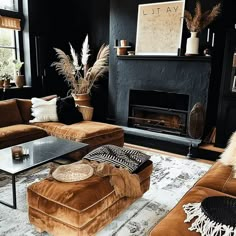 a living room filled with furniture and a fire place in the middle of the room