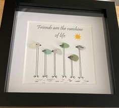 three birds sitting on top of each other in front of a black frame with the words friends are the sunshine of life