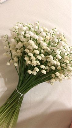 a bouquet of white flowers sitting on top of a table